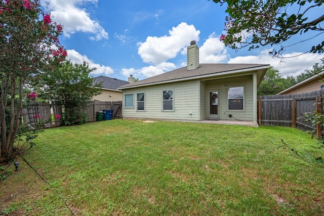 3809 Bronco Bend Loop, Austin, TX 78744 - back of house featuring a chimney and a patio area