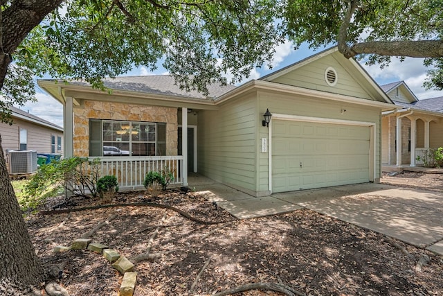 3809 Bronco Bend Loop, Austin, TX 78744 - ranch-style home featuring a porch, a garage, driveway, central air condition unit, and stone siding