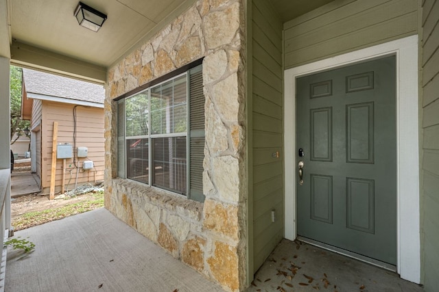 3809 Bronco Bend Loop, Austin, TX 78744 - entrance to property featuring stone siding and covered porch