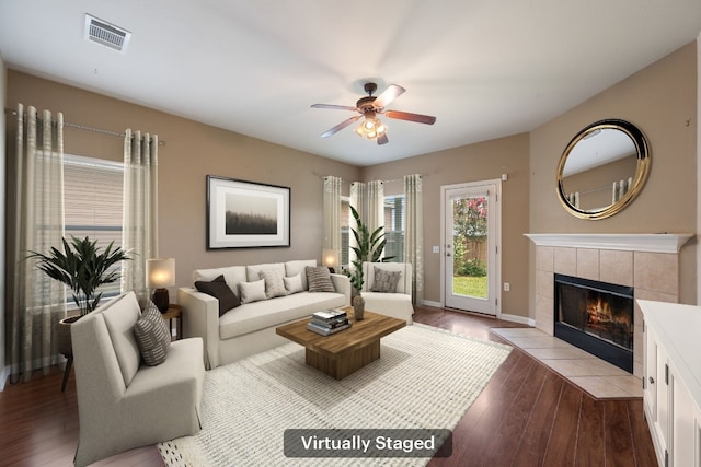 3809 Bronco Bend Loop, Austin, TX 78744 - living area with a ceiling fan, a fireplace, dark wood finished floors, and baseboards