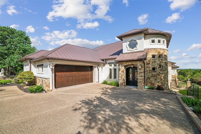 12529 Verandah Ct, Austin, TX 78726 - view of front of home with a standing seam roof, stone siding, driveway, and an attached garage