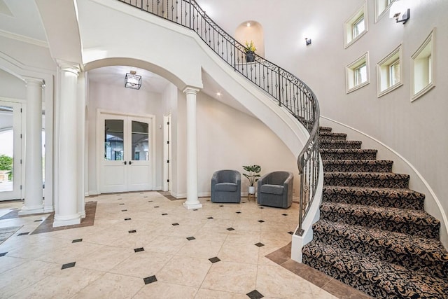 12529 Verandah Ct, Austin, TX 78726 - tiled foyer featuring decorative columns, a high ceiling, stairway, and arched walkways