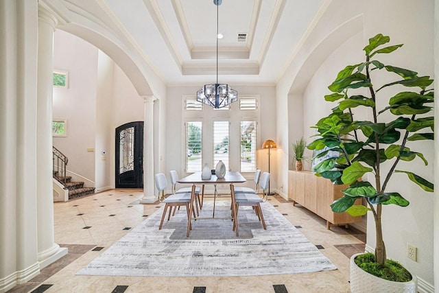 12529 Verandah Ct, Austin, TX 78726 - dining area with ornate columns, arched walkways, a tray ceiling, plenty of natural light, and a towering ceiling
