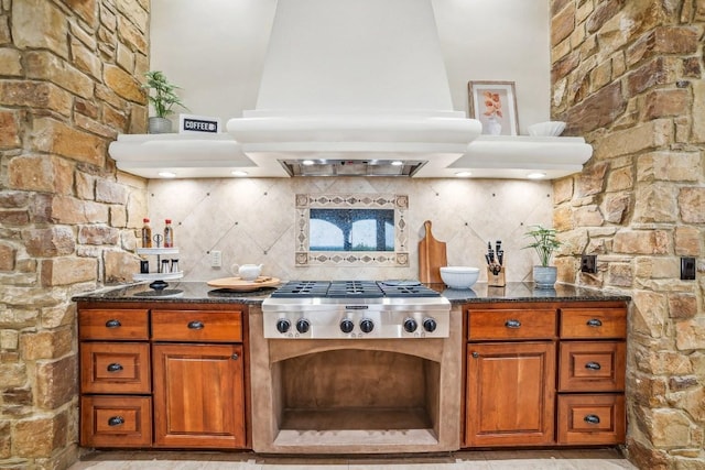 12529 Verandah Ct, Austin, TX 78726 - kitchen featuring stainless steel gas stovetop, custom range hood, brown cabinets, and dark stone counters