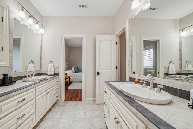 12529 Verandah Ct, Austin, TX 78726 - ensuite bathroom with two vanities and baseboards