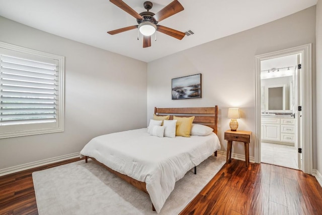 12529 Verandah Ct, Austin, TX 78726 - bedroom with dark wood-style floors, ensuite bath, and ceiling fan