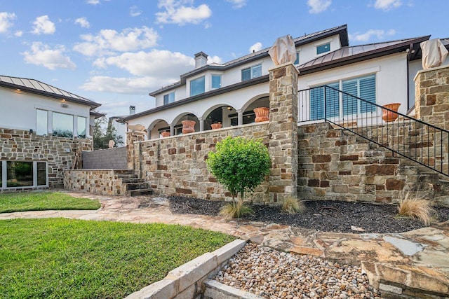 12529 Verandah Ct, Austin, TX 78726 - view of front of property with a standing seam roof, stairs, stucco siding, a metal roof, and a front yard