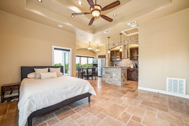 12529 Verandah Ct, Austin, TX 78726 - bedroom with a raised ceiling, freestanding refrigerator, recessed lighting, and stone tile flooring