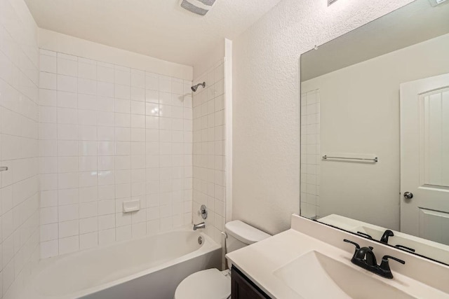 14309 Deaf Smith Blvd, Austin, TX 78725 - bathroom with toilet, vanity, bathtub / shower combination, and a textured wall