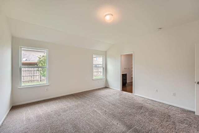 14309 Deaf Smith Blvd, Austin, TX 78725 - carpeted spare room featuring baseboards, plenty of natural light, vaulted ceiling, and a smoke detector