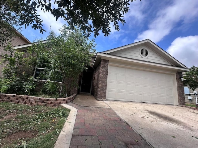 14309 Deaf Smith Blvd, Austin, TX 78725 - ranch-style home with concrete driveway, brick siding, and a garage