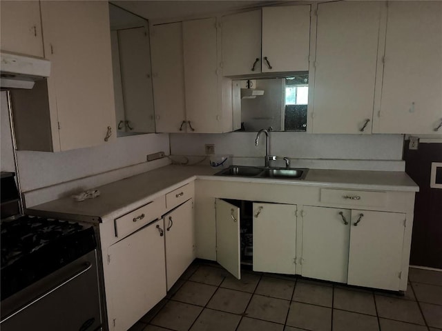 200 W Odell St, Austin, TX 78752 - kitchen featuring stainless steel gas range oven, exhaust hood, white cabinetry, light countertops, and light tile patterned flooring