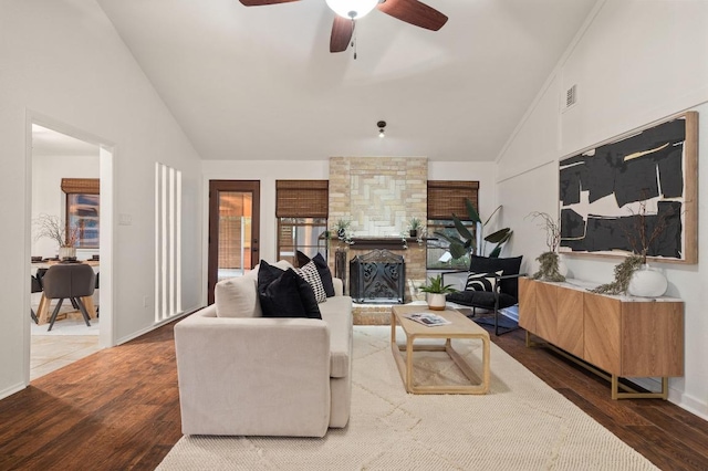 7701 Lowdes Dr, Austin, TX 78745 - living area with vaulted ceiling, wood finished floors, a ceiling fan, a fireplace, and baseboards