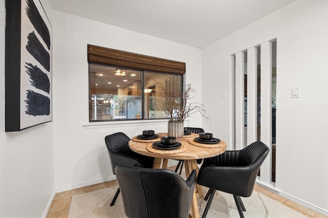 7701 Lowdes Dr, Austin, TX 78745 - tiled dining space featuring baseboards