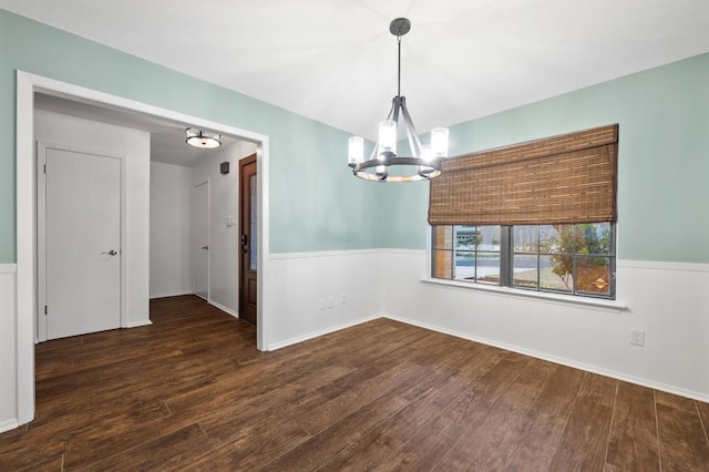 7701 Lowdes Dr, Austin, TX 78745 - unfurnished room with a chandelier, wood finished floors, and baseboards