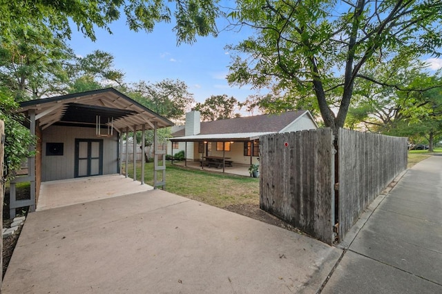 7701 Lowdes Dr, Austin, TX 78745 - exterior space featuring driveway, a carport, and an outbuilding