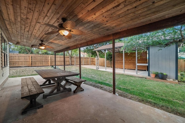 7701 Lowdes Dr, Austin, TX 78745 - view of patio with outdoor dining space, ceiling fan, and an outbuilding