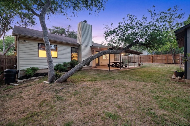 7701 Lowdes Dr, Austin, TX 78745 - back of property with a chimney, a patio area, and a fenced backyard