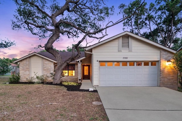 7701 Lowdes Dr, Austin, TX 78745 - mid-century modern home featuring concrete driveway, an attached garage, and brick siding