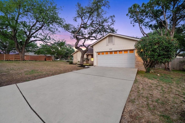7701 Lowdes Dr, Austin, TX 78745 - view of front facade featuring concrete driveway, an attached garage, and brick siding