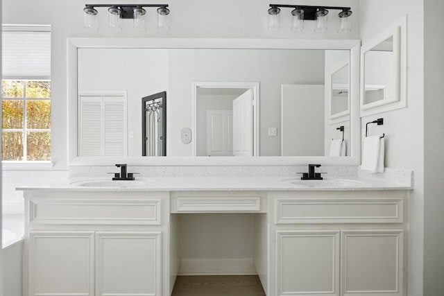 9205 Amanda Dr, Austin, TX 78729 - bathroom featuring double vanity and a bath