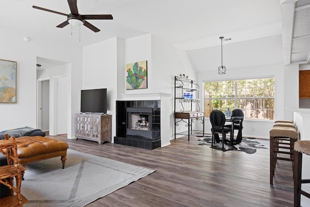 9205 Amanda Dr, Austin, TX 78729 - living area with ceiling fan, wood finished floors, a tile fireplace, and high vaulted ceiling