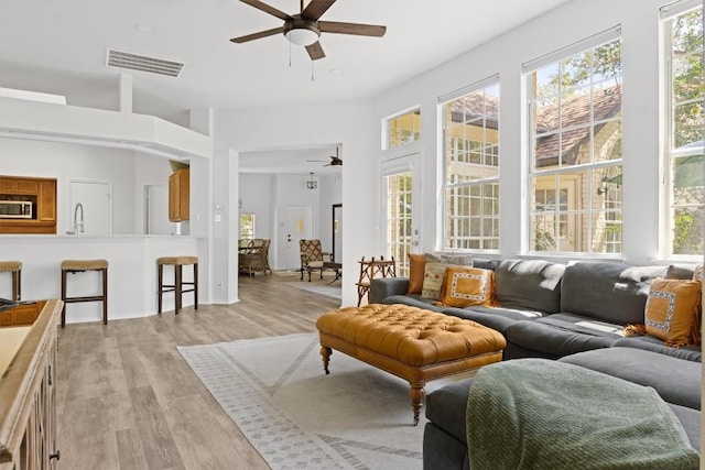 9205 Amanda Dr, Austin, TX 78729 - living area with a ceiling fan and light wood-type flooring