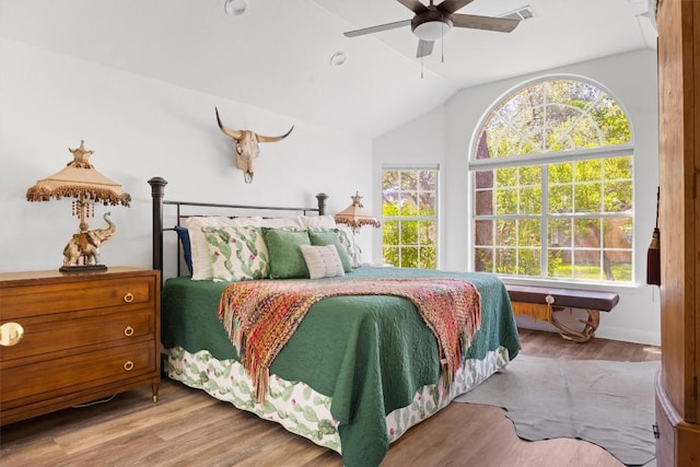 9205 Amanda Dr, Austin, TX 78729 - bedroom with wood finished floors, vaulted ceiling, and a ceiling fan