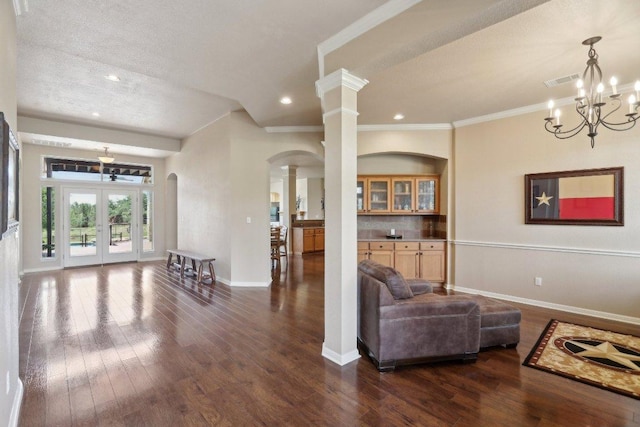 816 Drifting Wind Run, Dripping Springs, TX 78620 - living room featuring arched walkways, baseboards, dark wood-style flooring, french doors, and crown molding