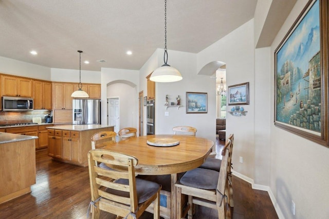 816 Drifting Wind Run, Dripping Springs, TX 78620 - dining room with arched walkways, dark wood finished floors, recessed lighting, and baseboards