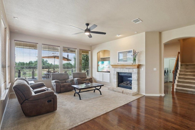 816 Drifting Wind Run, Dripping Springs, TX 78620 - living room with washer and dryer, a textured ceiling, wood finished floors, arched walkways, and ceiling fan