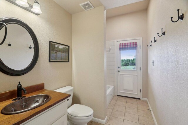 816 Drifting Wind Run, Dripping Springs, TX 78620 - bathroom with toilet, vanity, tile patterned flooring, baseboards, and a textured wall