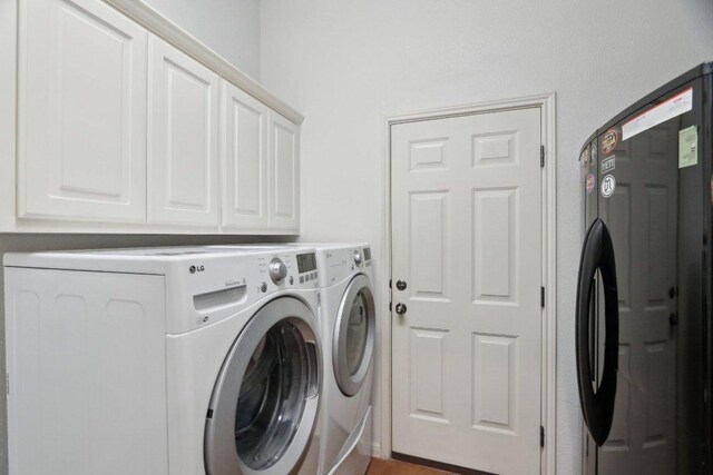 816 Drifting Wind Run, Dripping Springs, TX 78620 - washroom with washer and dryer and cabinet space