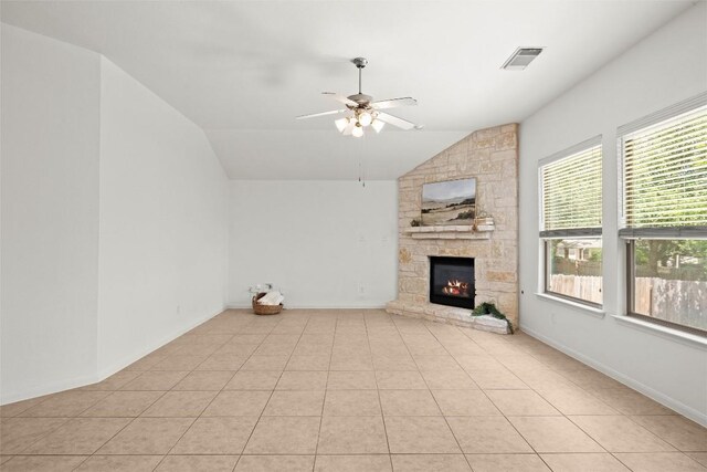 260 Kiras Ct, Austin, TX 78737 - unfurnished living room featuring vaulted ceiling, healthy amount of natural light, ceiling fan, a stone fireplace, and light tile patterned floors
