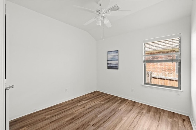 260 Kiras Ct, Austin, TX 78737 - empty room featuring wood finished floors, ceiling fan, baseboards, and lofted ceiling
