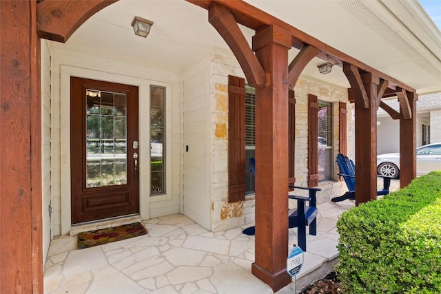260 Kiras Ct, Austin, TX 78737 - doorway to property with covered porch and stone siding