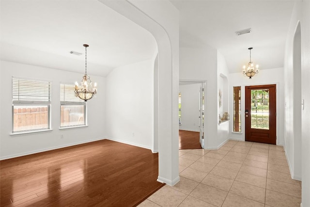 260 Kiras Ct, Austin, TX 78737 - foyer with a chandelier, vaulted ceiling, arched walkways, and baseboards