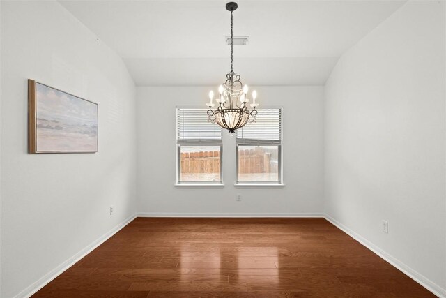 260 Kiras Ct, Austin, TX 78737 - spare room featuring vaulted ceiling, a chandelier, dark wood-type flooring, and baseboards