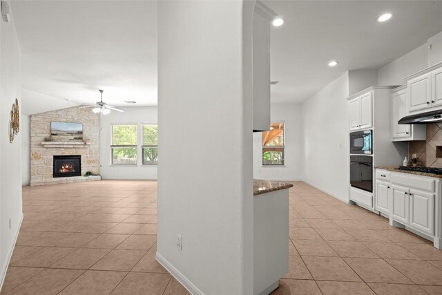 260 Kiras Ct, Austin, TX 78737 - kitchen featuring black appliances, light tile patterned floors, ceiling fan, decorative backsplash, and white cabinetry