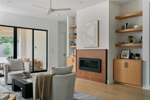 7809 Hardy Dr, Austin, TX 78757 - living area featuring light wood-style floors, a glass covered fireplace, and ceiling fan