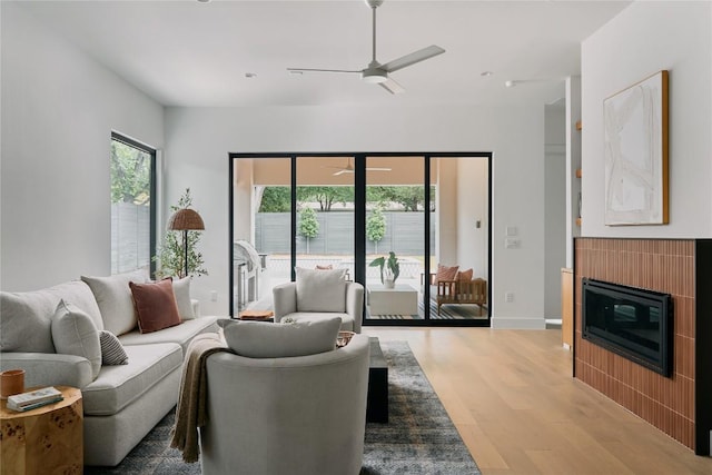 7809 Hardy Dr, Austin, TX 78757 - living area featuring light wood-style floors, a ceiling fan, and a glass covered fireplace