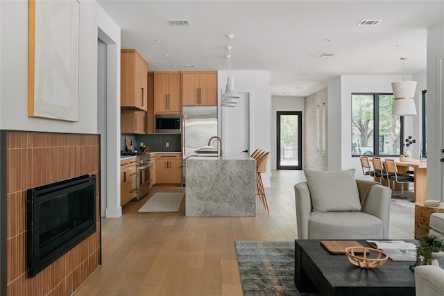 7809 Hardy Dr, Austin, TX 78757 - living area featuring light wood-style flooring, a fireplace, and recessed lighting