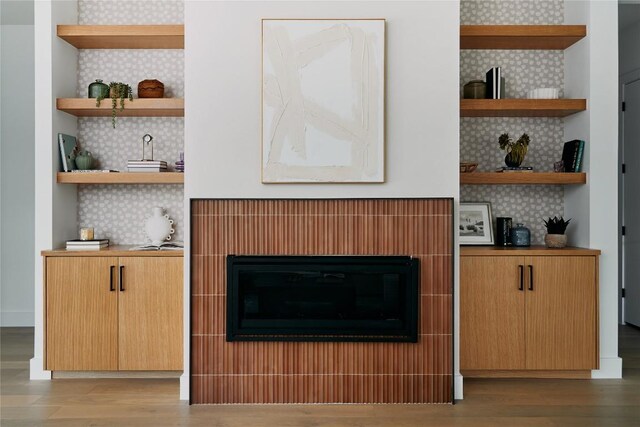 7809 Hardy Dr, Austin, TX 78757 - detailed view of tasteful backsplash, wood finished floors, and a fireplace