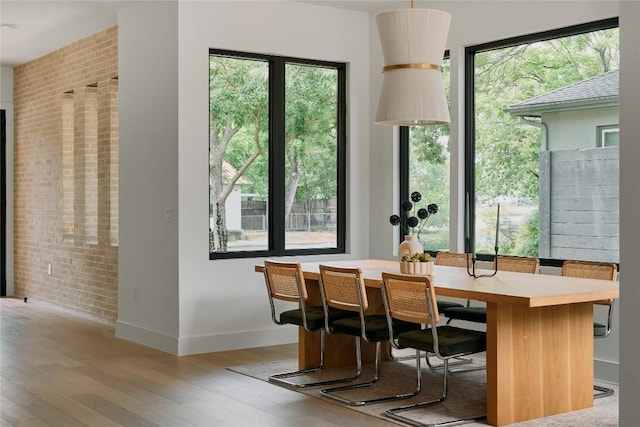 7809 Hardy Dr, Austin, TX 78757 - dining room featuring brick wall and wood finished floors