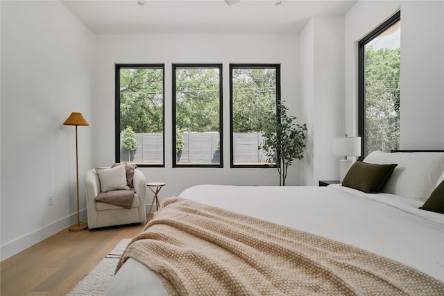 7809 Hardy Dr, Austin, TX 78757 - bedroom featuring multiple windows and light wood-style flooring