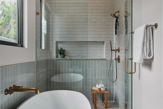 7809 Hardy Dr, Austin, TX 78757 - bathroom with a shower stall, a freestanding tub, and tile walls