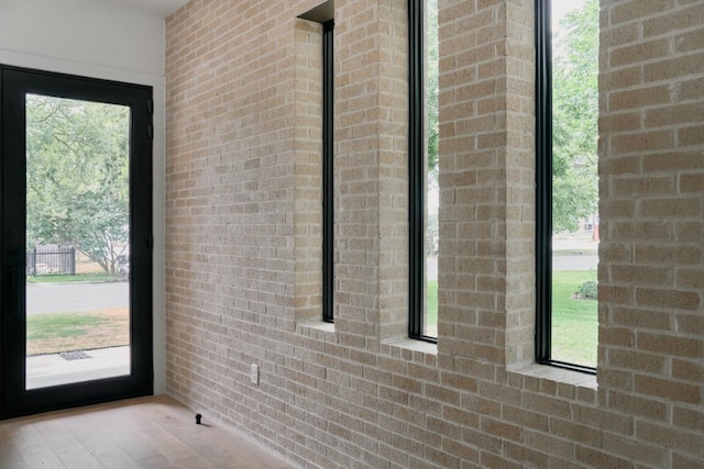7809 Hardy Dr, Austin, TX 78757 - doorway with brick wall and wood finished floors