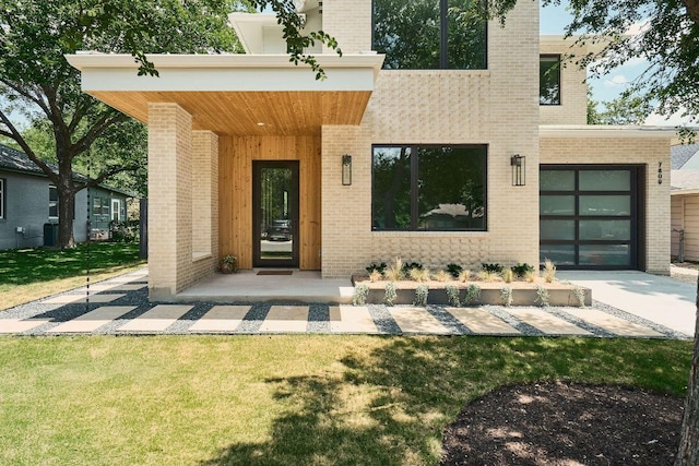7809 Hardy Dr, Austin, TX 78757 - rear view of property with brick siding, a lawn, a garage, and driveway