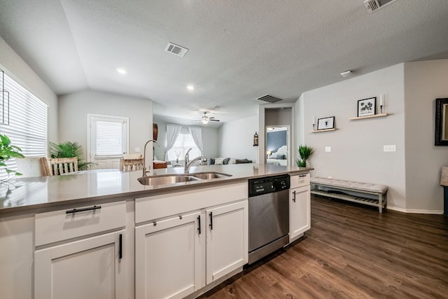 5817 Bell Tower Ln, Austin, TX 78747 - kitchen with dishwasher, a sink, white cabinetry, dark wood-style flooring, and vaulted ceiling