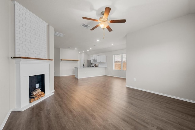 5817 Bell Tower Ln, Austin, TX 78747 - unfurnished living room featuring a ceiling fan, dark wood finished floors, a fireplace, and recessed lighting